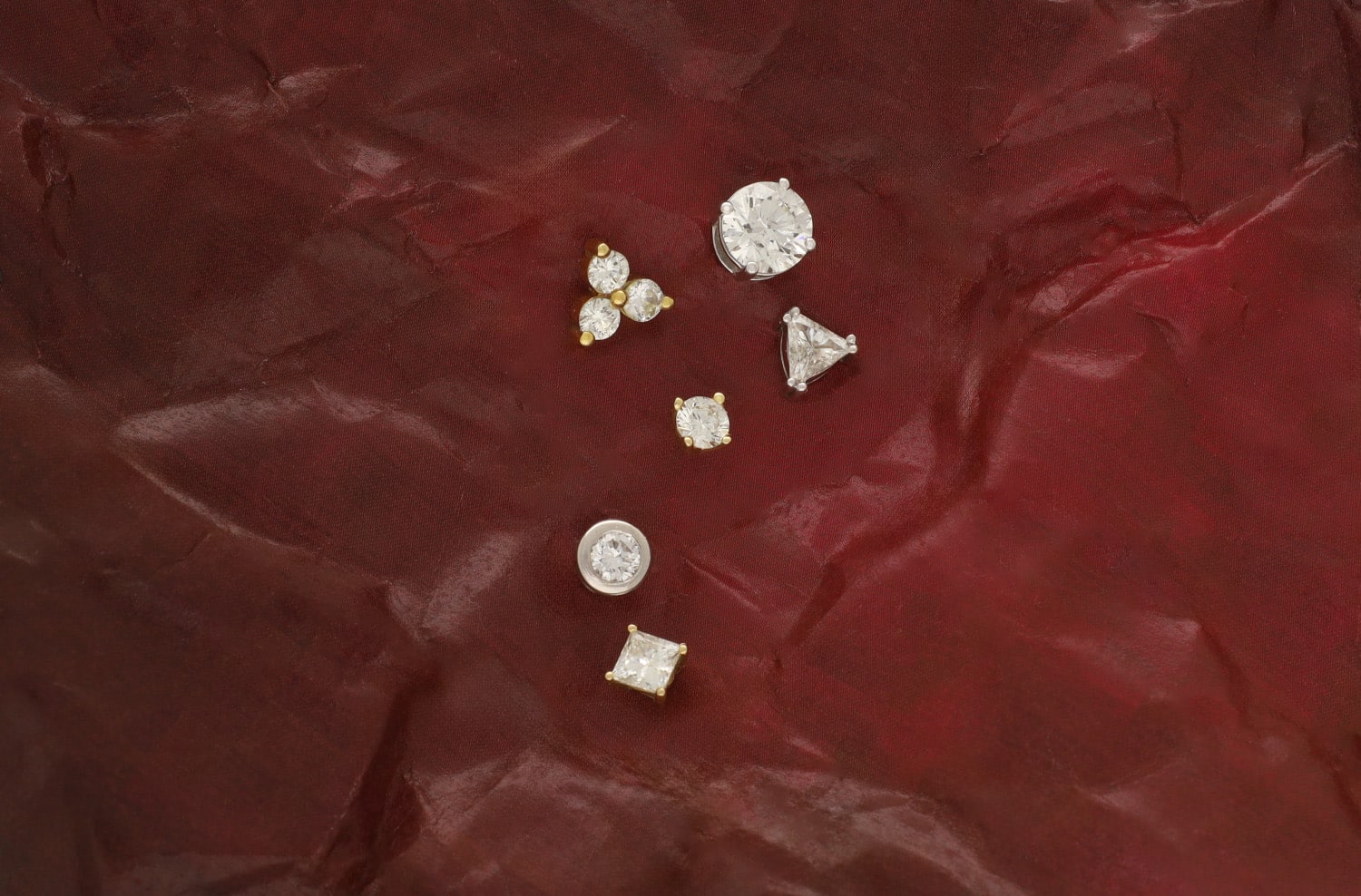 White and yellow gold diamond studs in different sizes and shapes